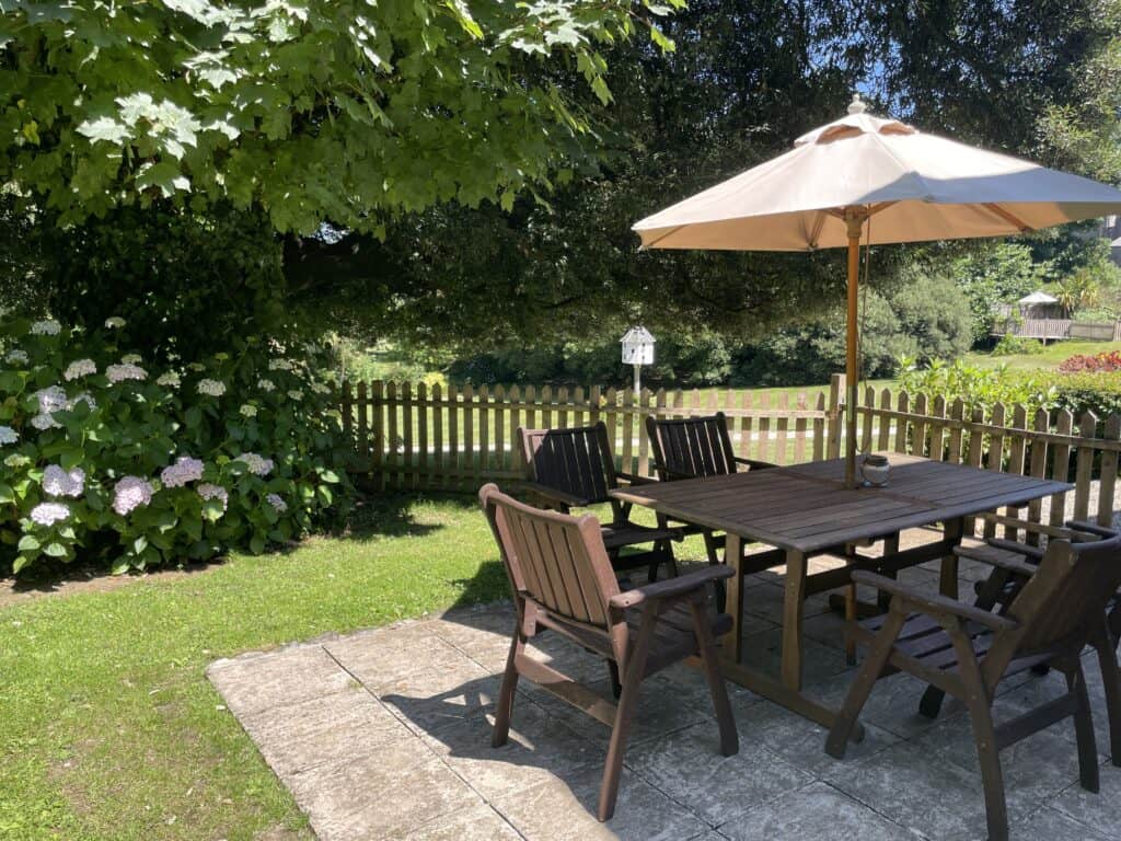 Enclosed private garden with outdoor seating at Holm Oak Cottage near Looe, Cornwall